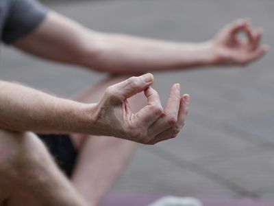 Detail of hands in a meditative pose.